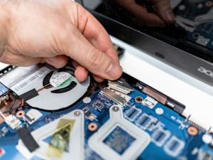 man fixing the motherboard on the laptop