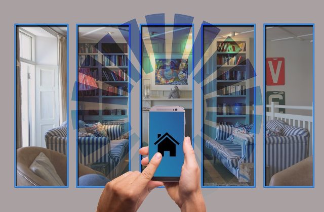 Person using a smartphone to control smart home security in a modern rental apartment