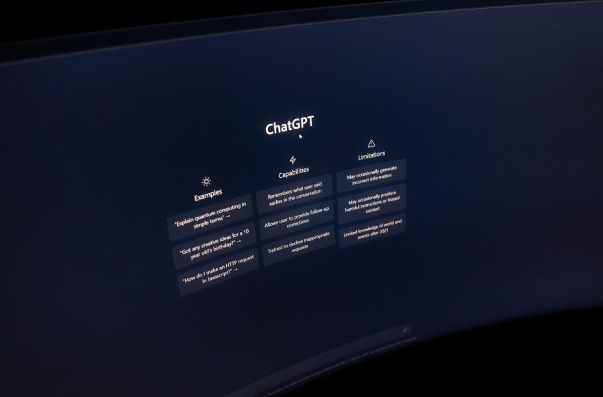 ChatGPT interface displayed on a monitor showing examples, capabilities, and limitations panels