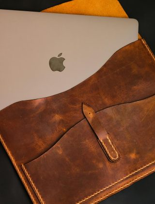 MacBok Air sliding in the leather pouch
