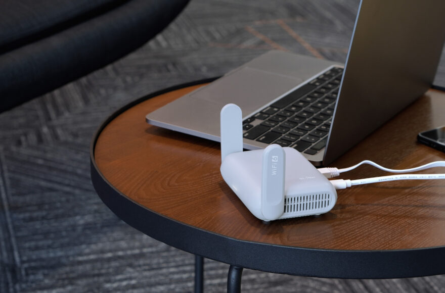 best-travel-router-2026-laptop-coffee-shop-setup.jpg